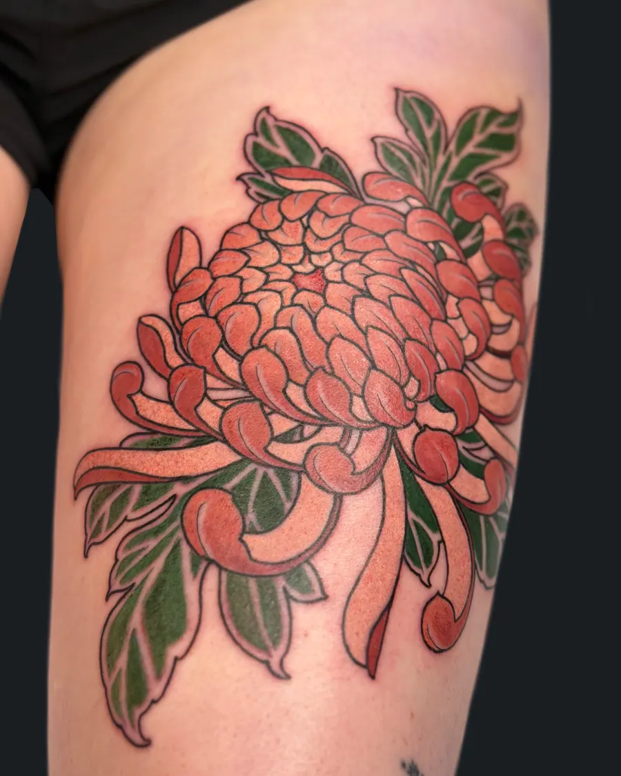 Neotraditional coral chrysanthemum tattoo with green leaves on the thigh by English Cousins, Nashville