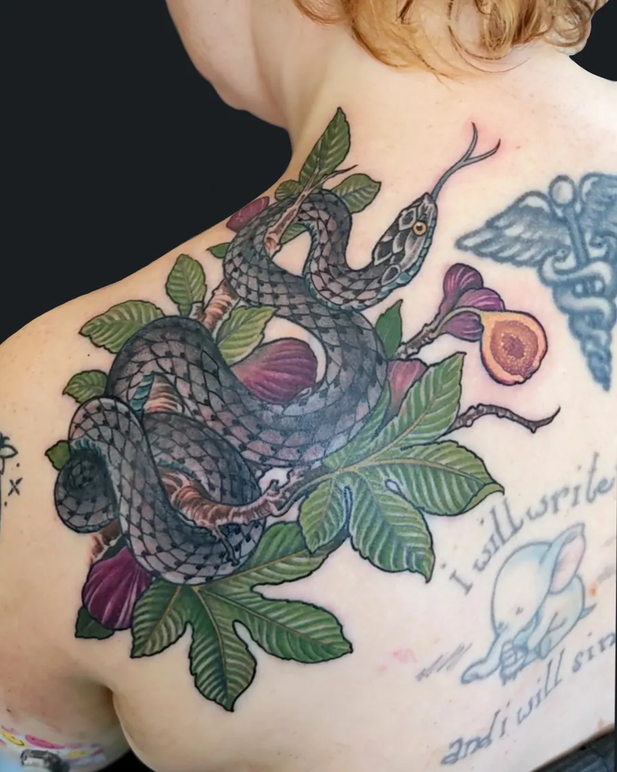 Tattoo of a snake coiled around fig branches, leaves, and fruit on the shoulder and upper back by English Cousins, Nashville