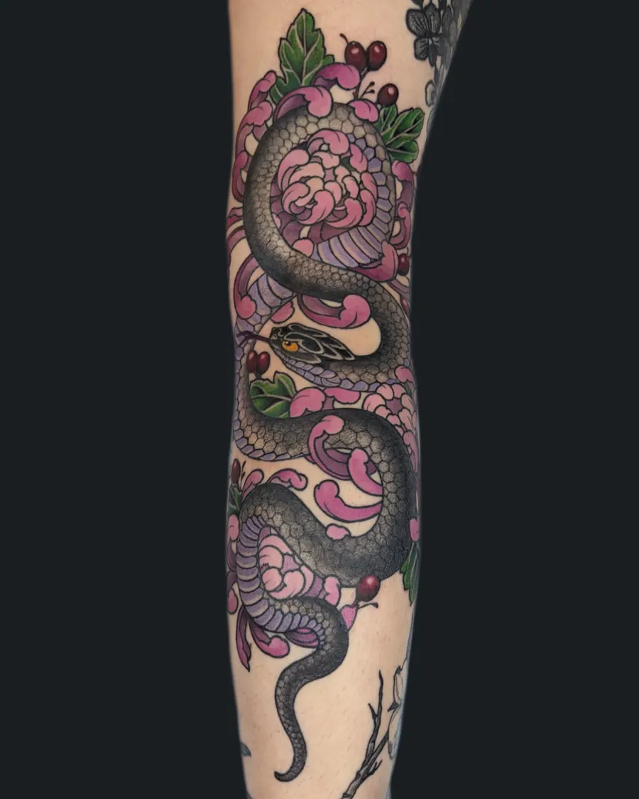 Japanese snake tattoo winding through pink and purple chrysanthemums down the arm by English Cousins, Nashville